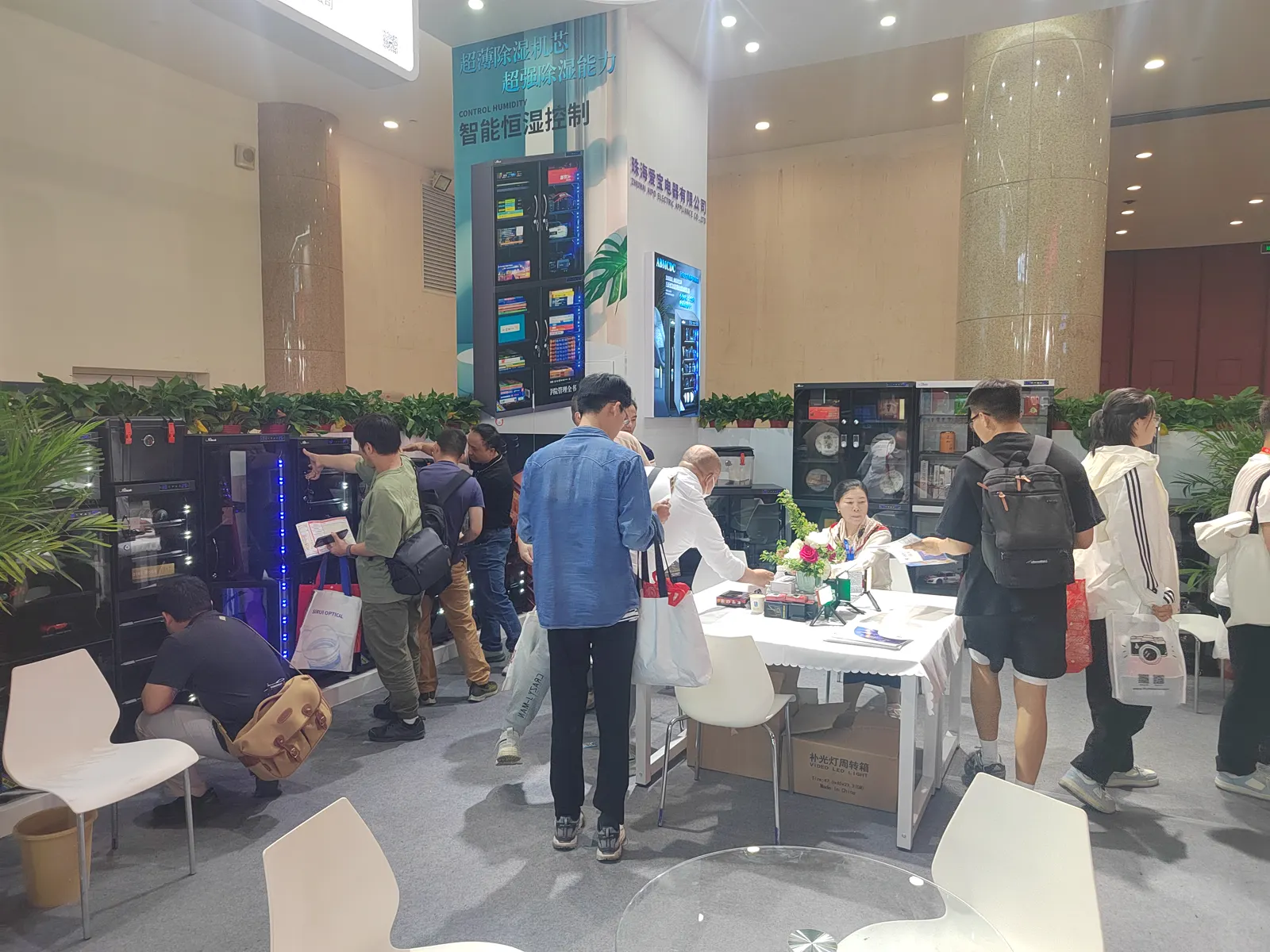 Visitors viewing ABMCDC dry cabinets at a Beijing photography equipment exhibition